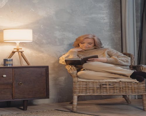 A person relaxing reading a book in a comfortable setting