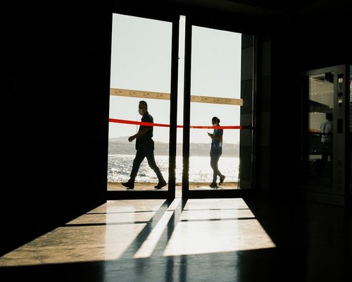 Walking short distance indoors towards a window