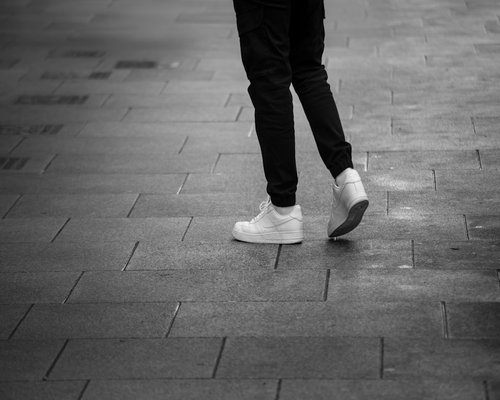 Comfortable sneakers walking on urban pavement